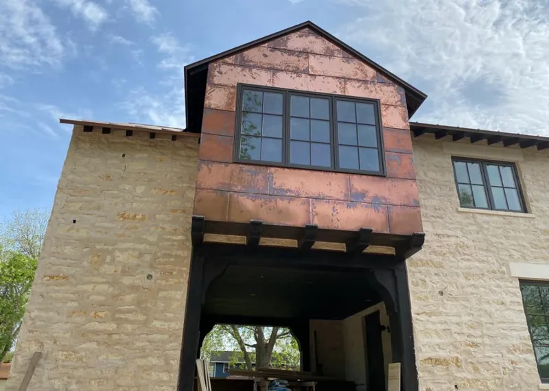 Copper metal panel facade on a stone building for Roof Repair in Holly Hill