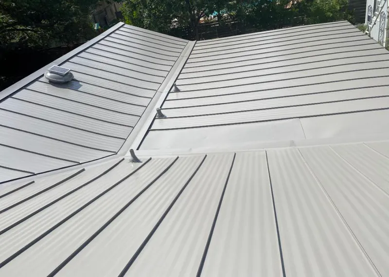 Solar attic fan installed on a metal roof for Roof Ventilation in Holly Hill